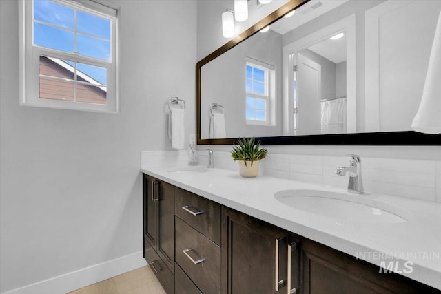 2959 S Shady Ln, Boise, ID 83716 - full bathroom featuring baseboards, double vanity, and backsplash
