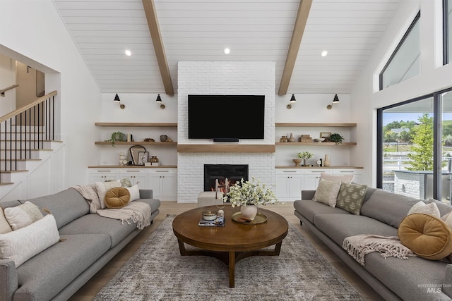 11950 W Lanktree Gulch Rd, Star, ID 83669 - living room featuring light wood-type flooring, beam ceiling, stairway, a brick fireplace, and high vaulted ceiling