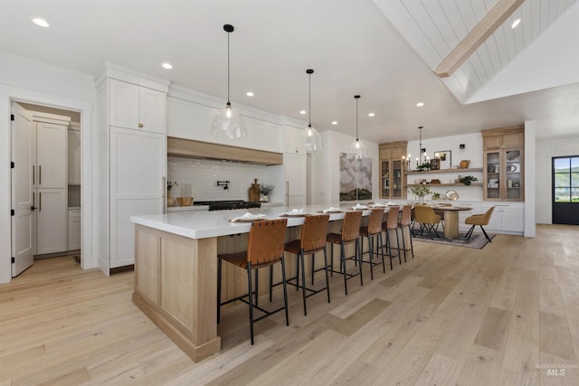 11950 W Lanktree Gulch Rd, Star, ID 83669 - kitchen with open shelves, a chandelier, light wood-style floors, backsplash, and light countertops