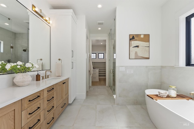 11950 W Lanktree Gulch Rd, Star, ID 83669 - full bath with vanity, a shower stall, a freestanding tub, recessed lighting, and tile patterned flooring
