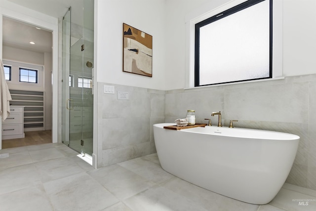 11950 W Lanktree Gulch Rd, Star, ID 83669 - bathroom featuring tile walls, a shower stall, a freestanding bath, and a wainscoted wall
