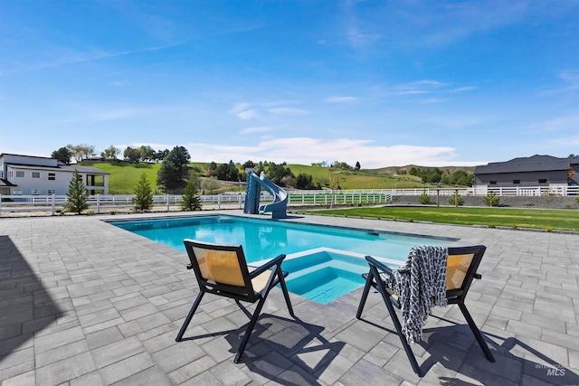 11950 W Lanktree Gulch Rd, Star, ID 83669 - view of swimming pool with a water slide, a fenced backyard, a patio, and a pool with connected hot tub