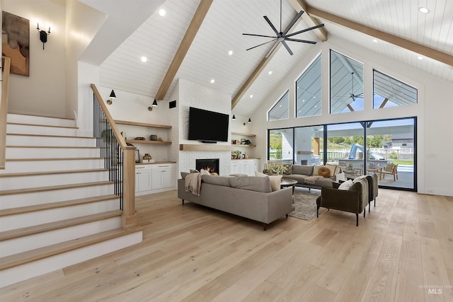 11950 W Lanktree Gulch Rd, Star, ID 83669 - living area with high vaulted ceiling, ceiling fan, light wood finished floors, a fireplace, and stairs