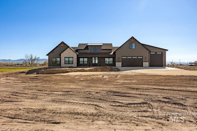 2240 Little Rock Rd, Emmett, ID 83616 - modern inspired farmhouse featuring concrete driveway, a standing seam roof, metal roof, board and batten siding, and stone siding