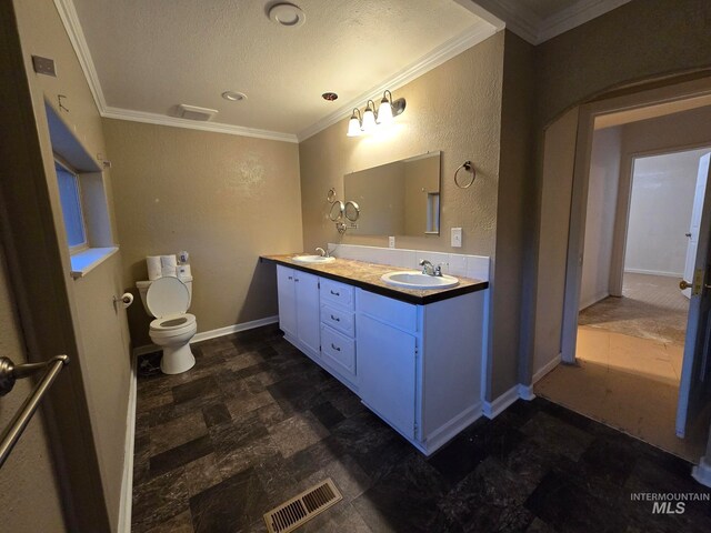 bathroom with ornamental molding, a textured ceiling, vanity, and toilet