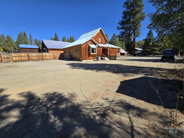 379 S Mill St, Sumpter, OR 97877 - rear view of house featuring fence, entry steps, and board and batten siding