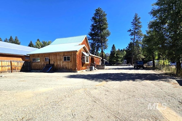 379 S Mill St, Sumpter, OR 97877 - view of property exterior with fence, dirt driveway, metal roof, board and batten siding, and cooling unit