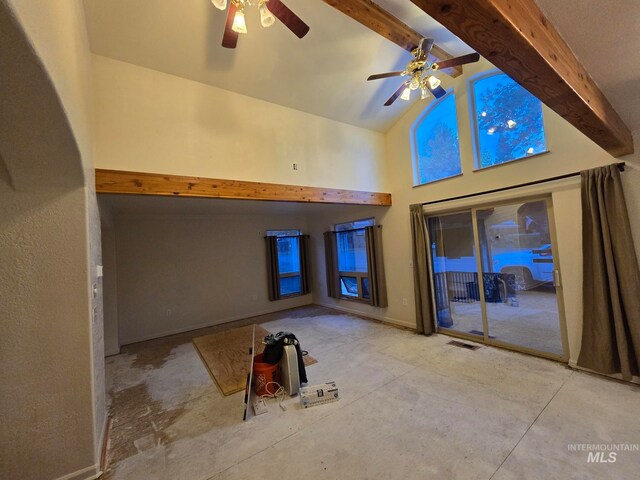 unfurnished living room with ceiling fan, high vaulted ceiling, and beamed ceiling