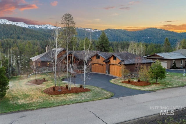 212 Ferguson Way, Mccall, ID 83638 - view of front facade with a mountain view, a chimney, and stone siding