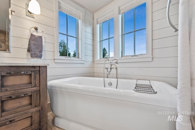 212 Ferguson Way, Mccall, ID 83638 - bathroom featuring a soaking tub and wooden walls