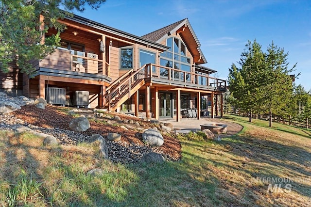 212 Ferguson Way, Mccall, ID 83638 - back of property with stairway, a deck, a yard, a fire pit, and a patio