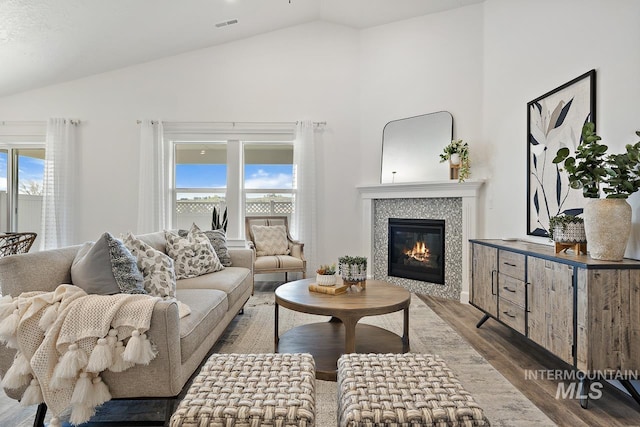 19126 Red Eagle Way, Caldwell, ID 83605 - living room with wood finished floors, a tiled fireplace, and high vaulted ceiling
