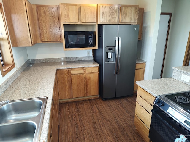 kitchen featuring black appliances, sink, and dark hardwood / wood-style floors