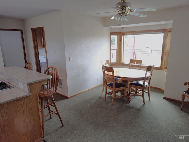 carpeted dining space with washer / clothes dryer and ceiling fan