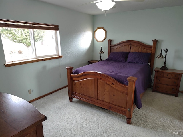 bedroom with light colored carpet and ceiling fan