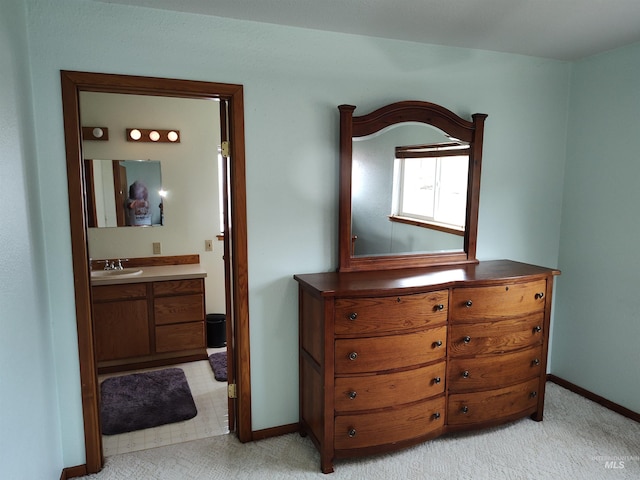 carpeted bedroom featuring ensuite bathroom