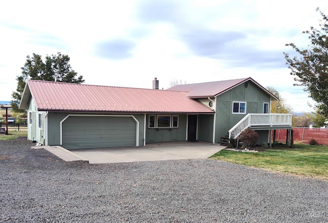 view of front facade featuring a front yard, a garage, and a carport