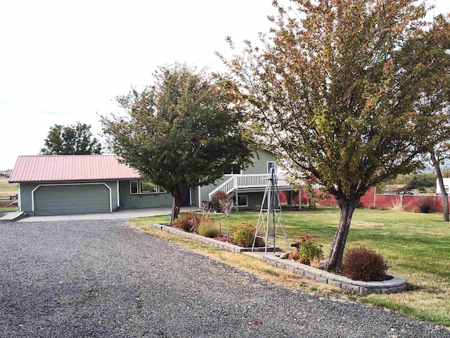 view of front of property featuring a front lawn and a garage