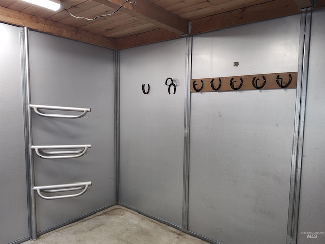 interior details featuring wood ceiling and concrete flooring