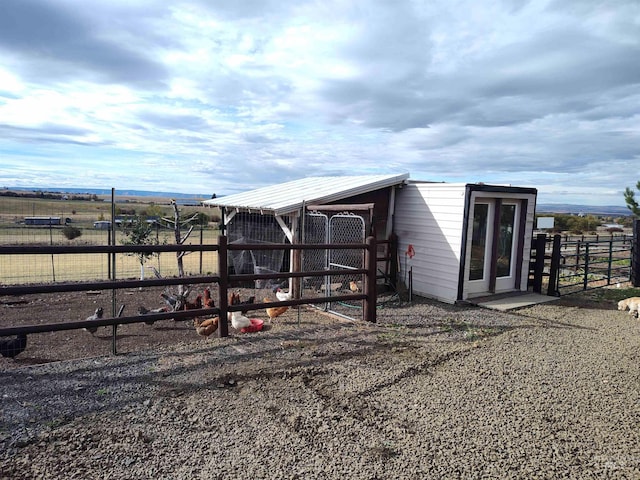 view of outdoor structure with a rural view