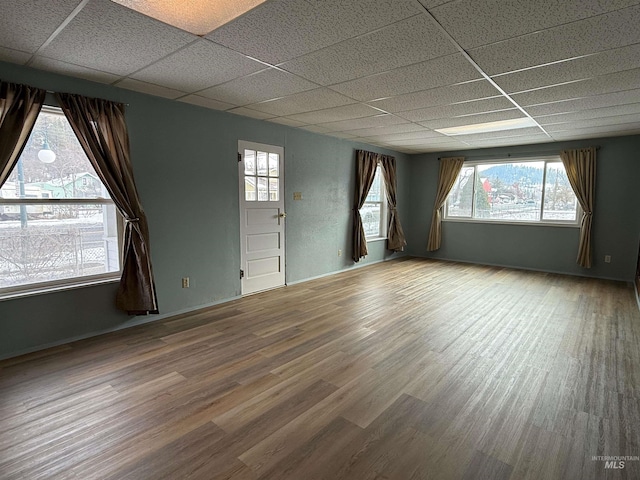 spare room featuring a drop ceiling and wood finished floors