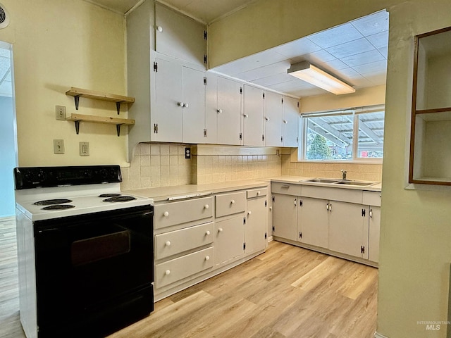 kitchen featuring electric stove, light countertops, open shelves, and white cabinetry