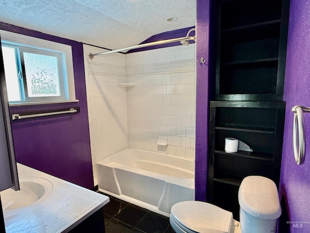 bathroom featuring a textured wall, tile patterned floors, a textured ceiling, vanity, and shower / bathing tub combination