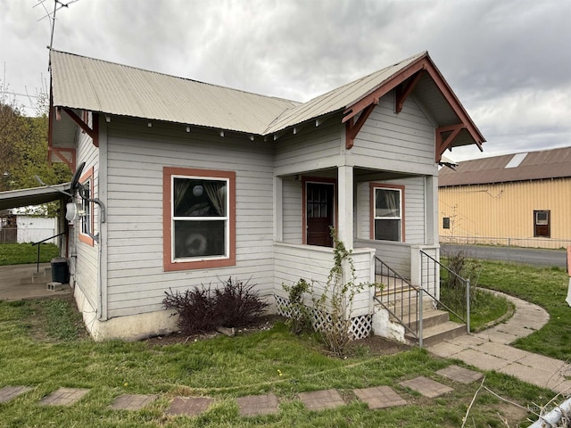 202 S Main St, Kooskia, ID 83539 - view of front facade featuring fence, a front yard, and metal roof