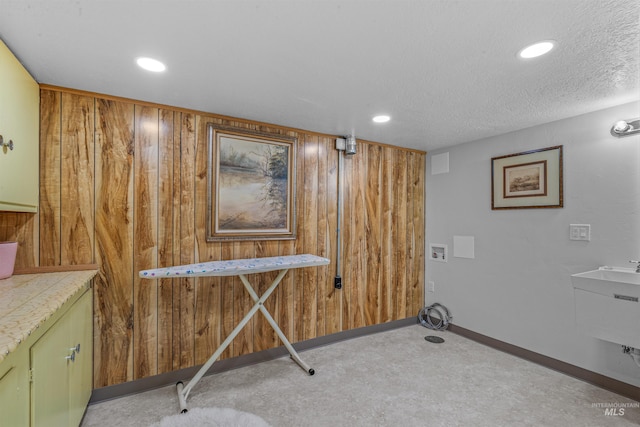 600 18th Ave, Lewiston, ID 83501 - interior space featuring wood walls, recessed lighting, a textured ceiling, hookup for a washing machine, and carpet