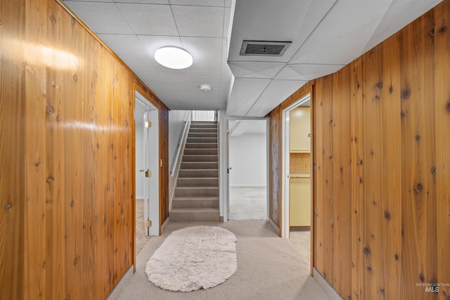 600 18th Ave, Lewiston, ID 83501 - hall with light carpet, stairway, a paneled ceiling, and wooden walls