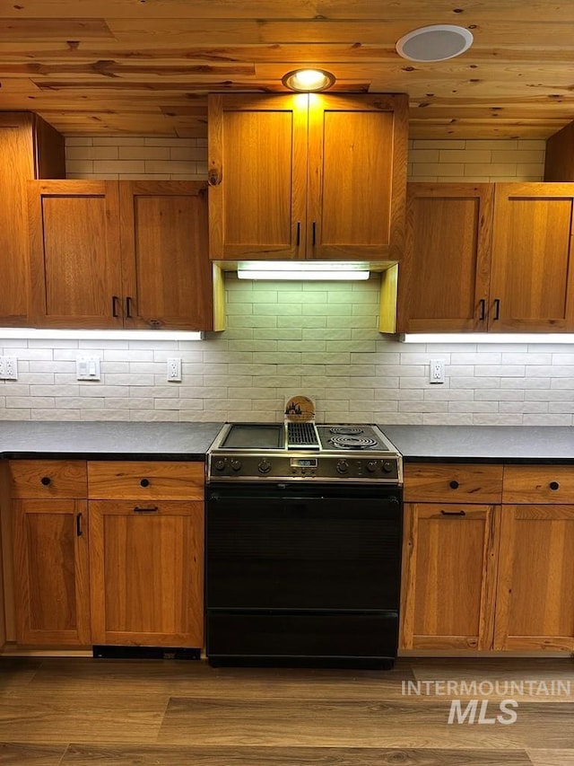 kitchen featuring brown cabinetry, wooden ceiling, and electric range