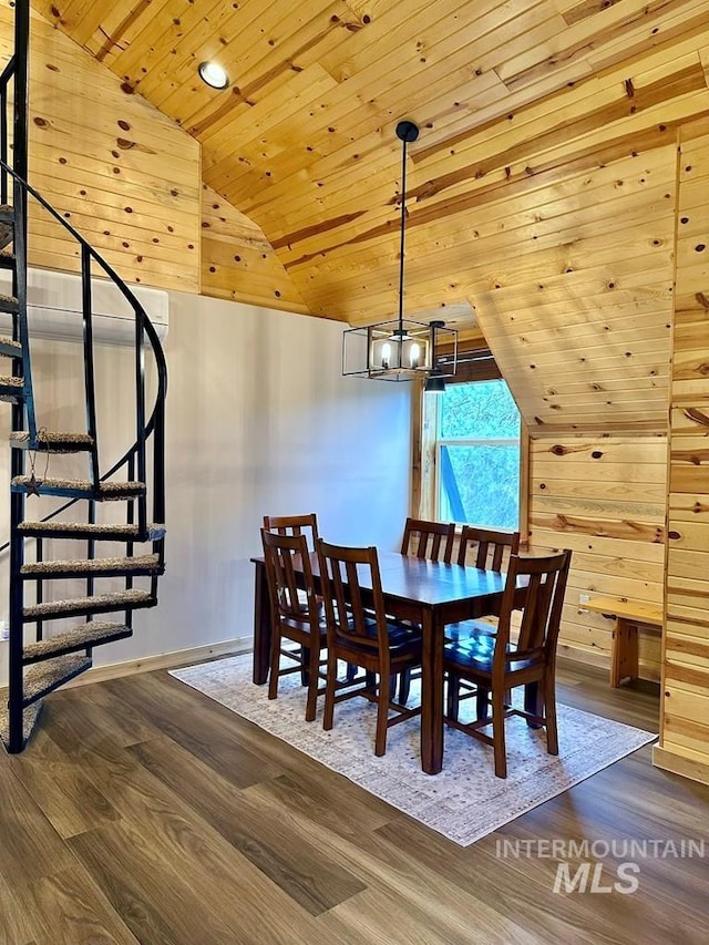 dining area with lofted ceiling, wooden ceiling, a chandelier, wood finished floors, and stairway
