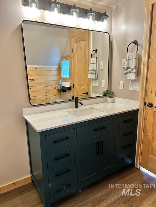 bathroom with vanity and wood finished floors