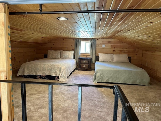 bedroom featuring wooden ceiling and wood walls