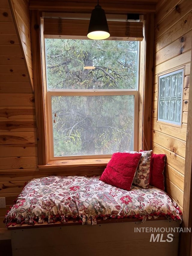 sitting room featuring wood walls