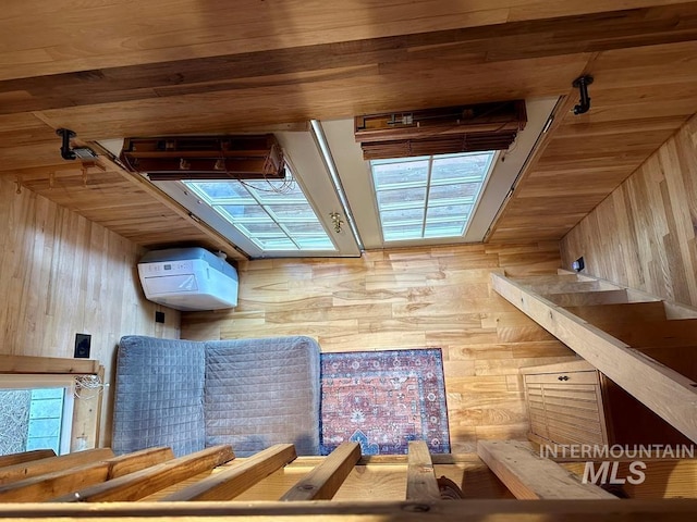 bonus room featuring wooden ceiling and wooden walls