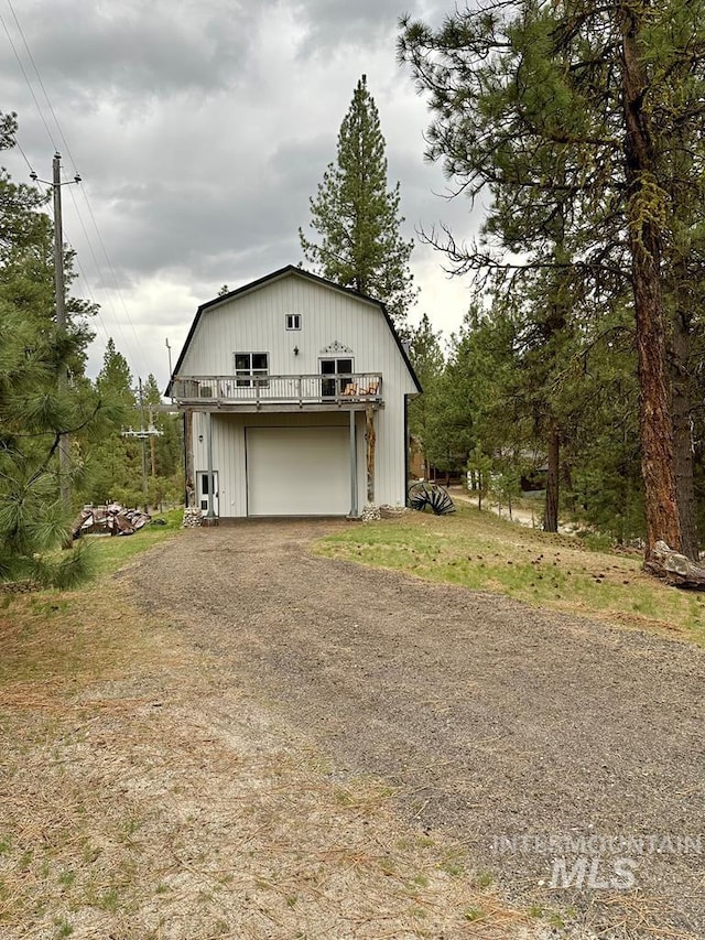 exterior space with driveway and a detached garage