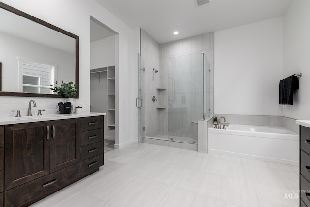 full bath featuring visible vents, a garden tub, vanity, and a shower stall