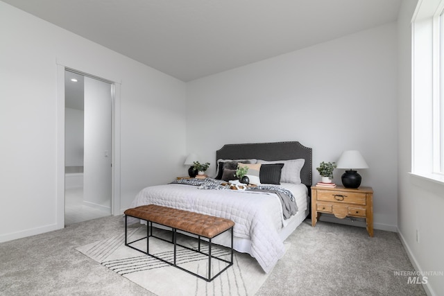 bedroom with baseboards and carpet flooring