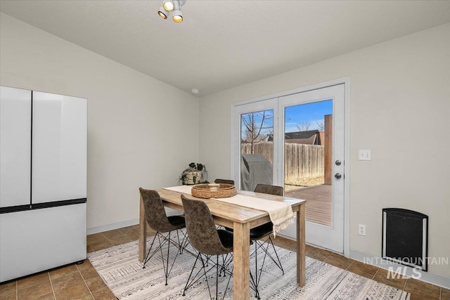 tiled dining area featuring lofted ceiling