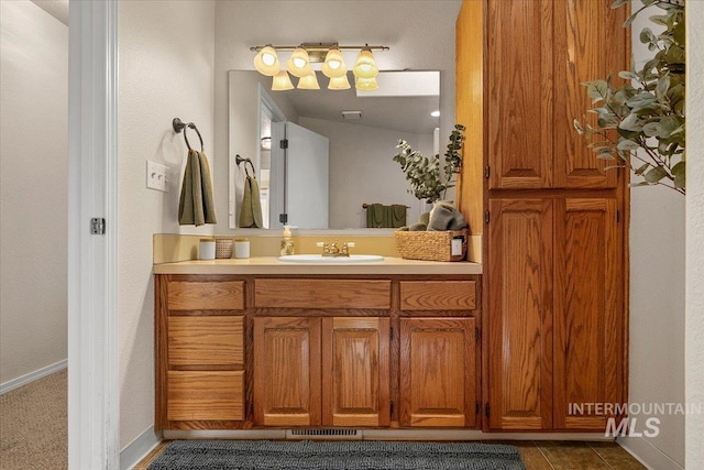 bathroom featuring tile patterned floors, vanity, and baseboards