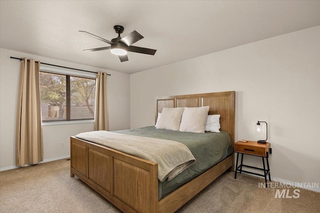 bedroom with baseboards, light colored carpet, and ceiling fan