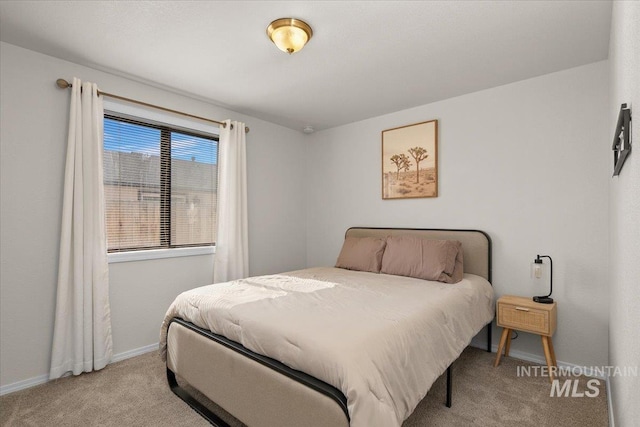 bedroom with light carpet and baseboards