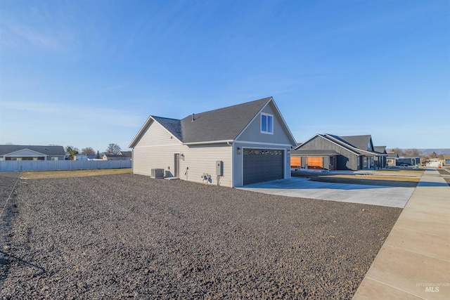 view of home's exterior featuring a garage, fence, and cooling unit