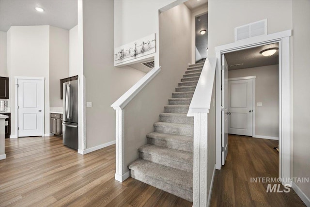 stairs with hardwood / wood-style floors