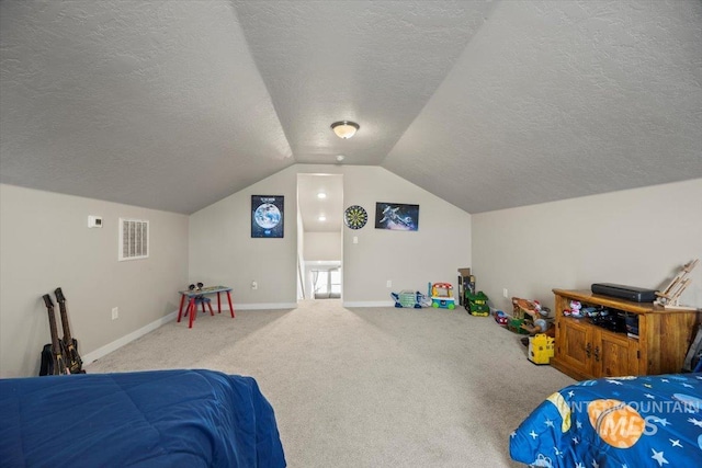 bedroom featuring lofted ceiling, carpet floors, and a textured ceiling