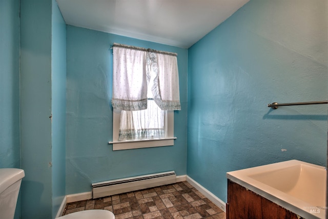 bathroom featuring toilet and a baseboard heating unit