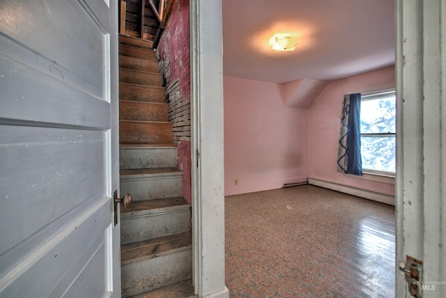 stairs featuring baseboard heating