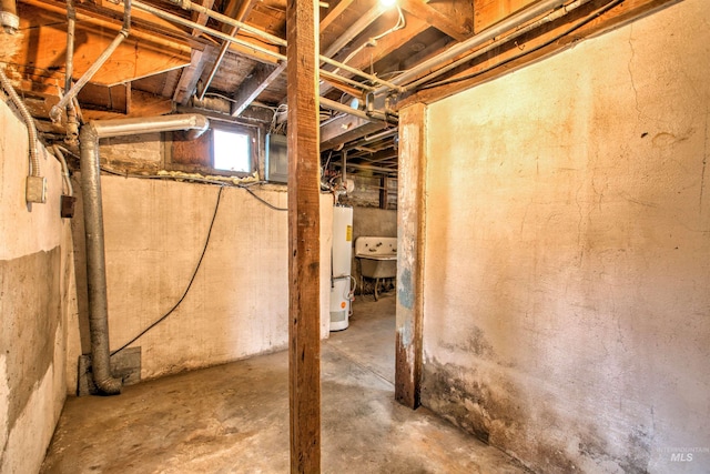 basement featuring sink and gas water heater