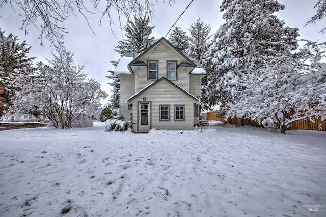 view of snow covered rear of property